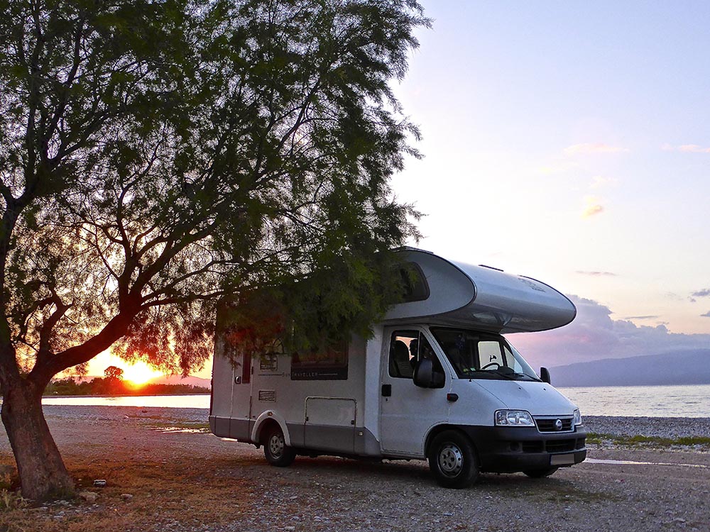 Camper van parked on beach