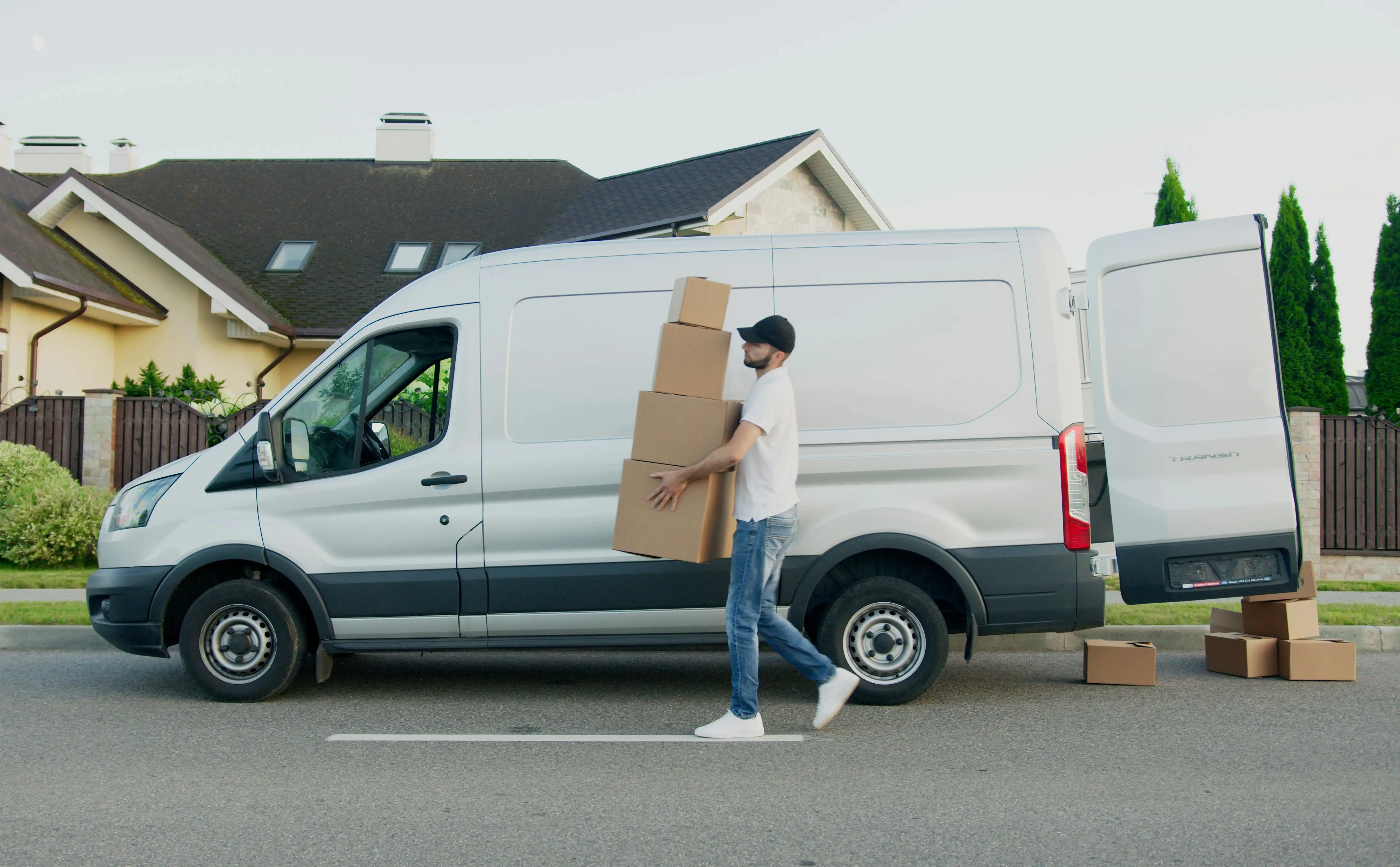 A man removes boxes from a hire van