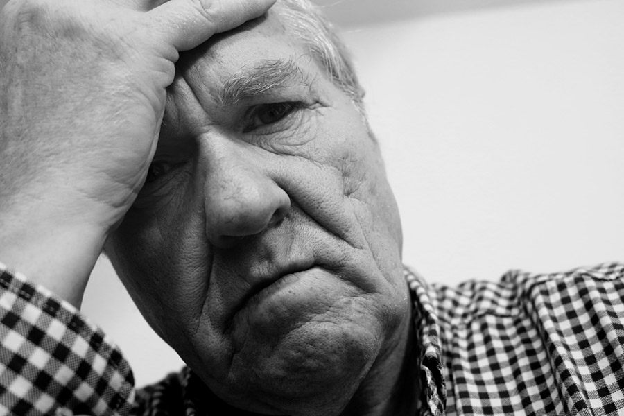 Man looking worried and in pain with shingles